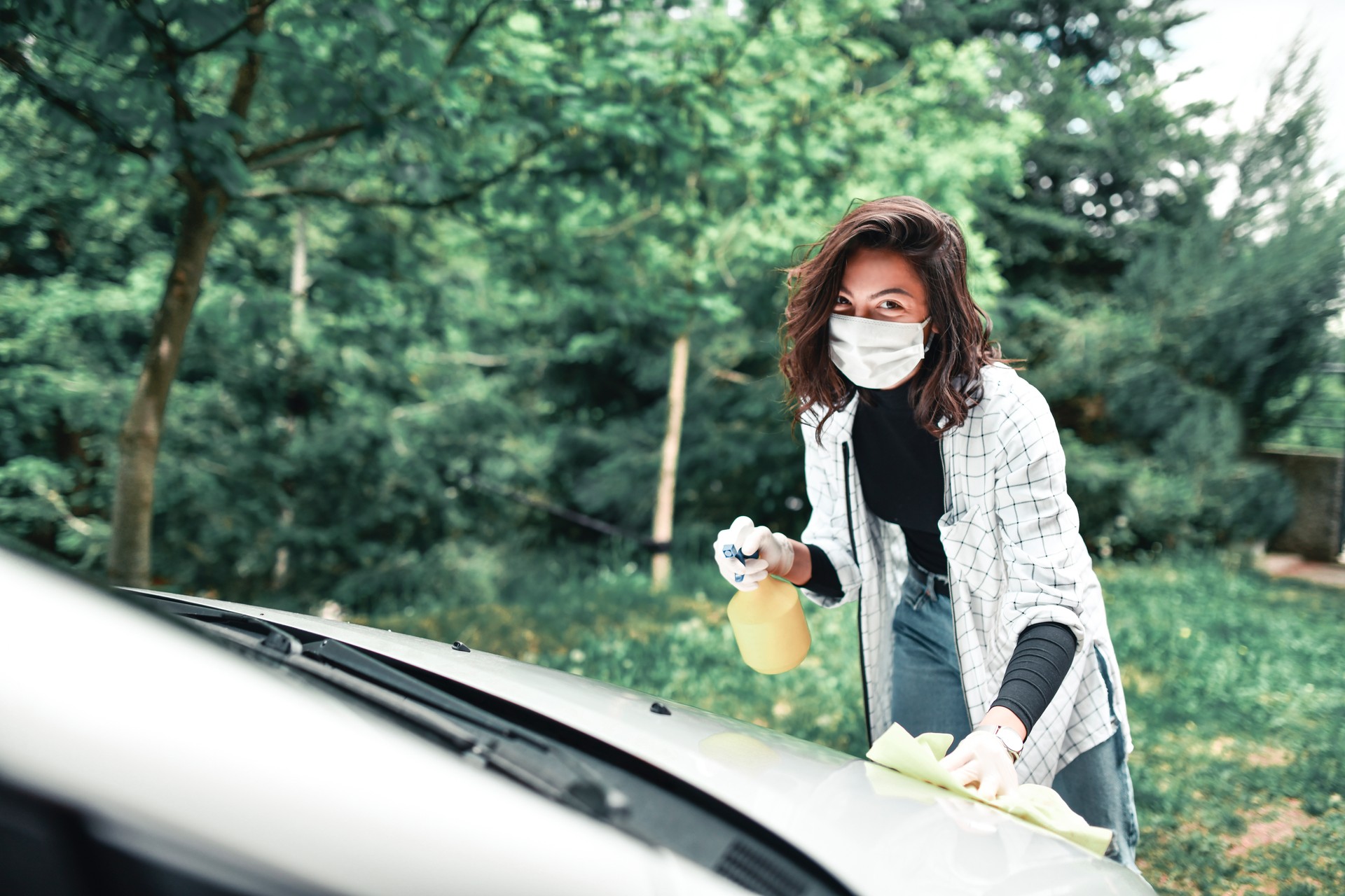 Female Disinfecting Car Exterior During Corona Pandemic